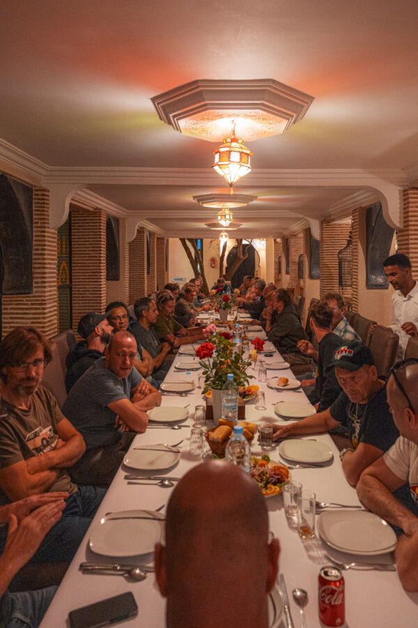 Group dinner at a long table in Morocco