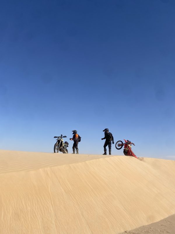 Riders on top of a dune in Mauritania