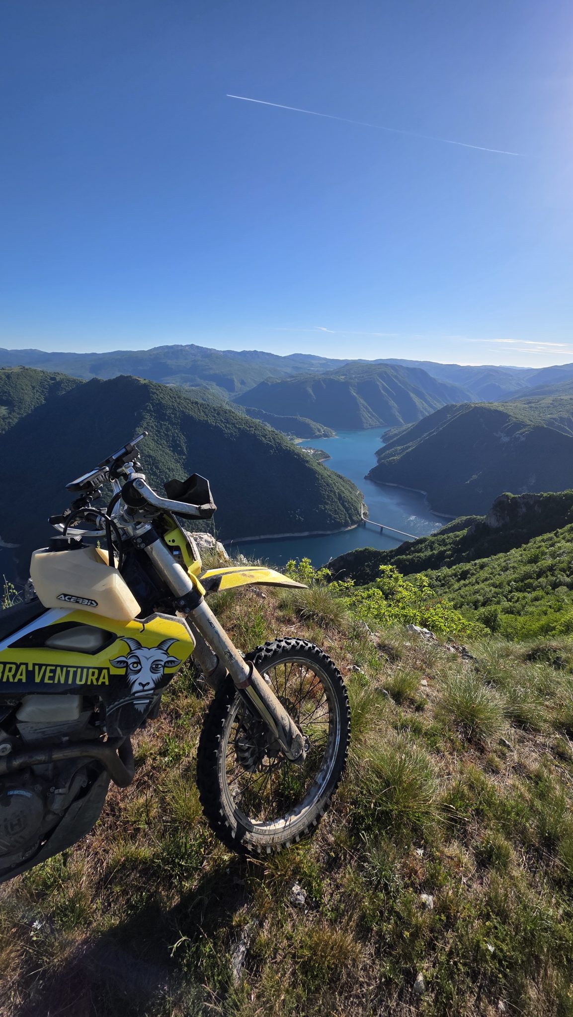 Enduro bike on a hilltop above a lake in Portugal
